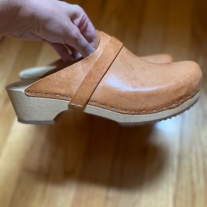 Clogs. Vegetable-tanned leather upper, wooden base, and rubber sole.